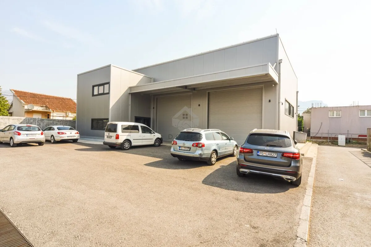Exterior view of a commercial building with warehouse space and parking in front.