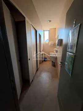 View of the bathroom with washbasins and tiling. - image 4