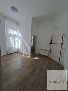 Empty room with laminate flooring, white walls, and a large window. - image 8