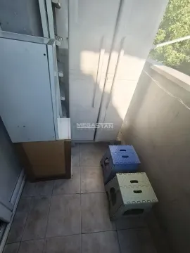 Smaller balcony with tiled floor and a storage cabinet. - image 11