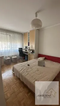 Furnished bedroom with a bed, desk, and wardrobe. - image 12
