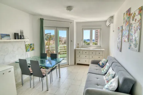 Living room with a sofa, dining table, and access to the terrace. - image 4