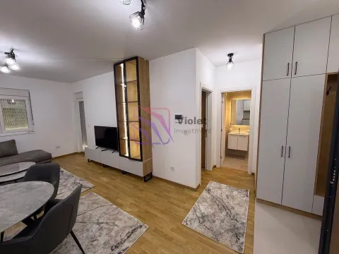 Living room with dining area and a built-in wardrobe in the hallway. - image 2
