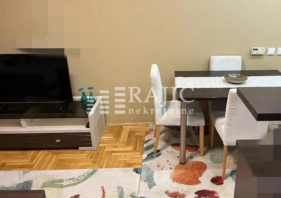 Living room with dining area and TV.