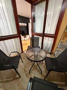 Enclosed terrace with patio furniture and a view into the apartment interior. - image 7