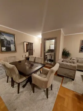 Living room with a dining table and chairs. - image 2