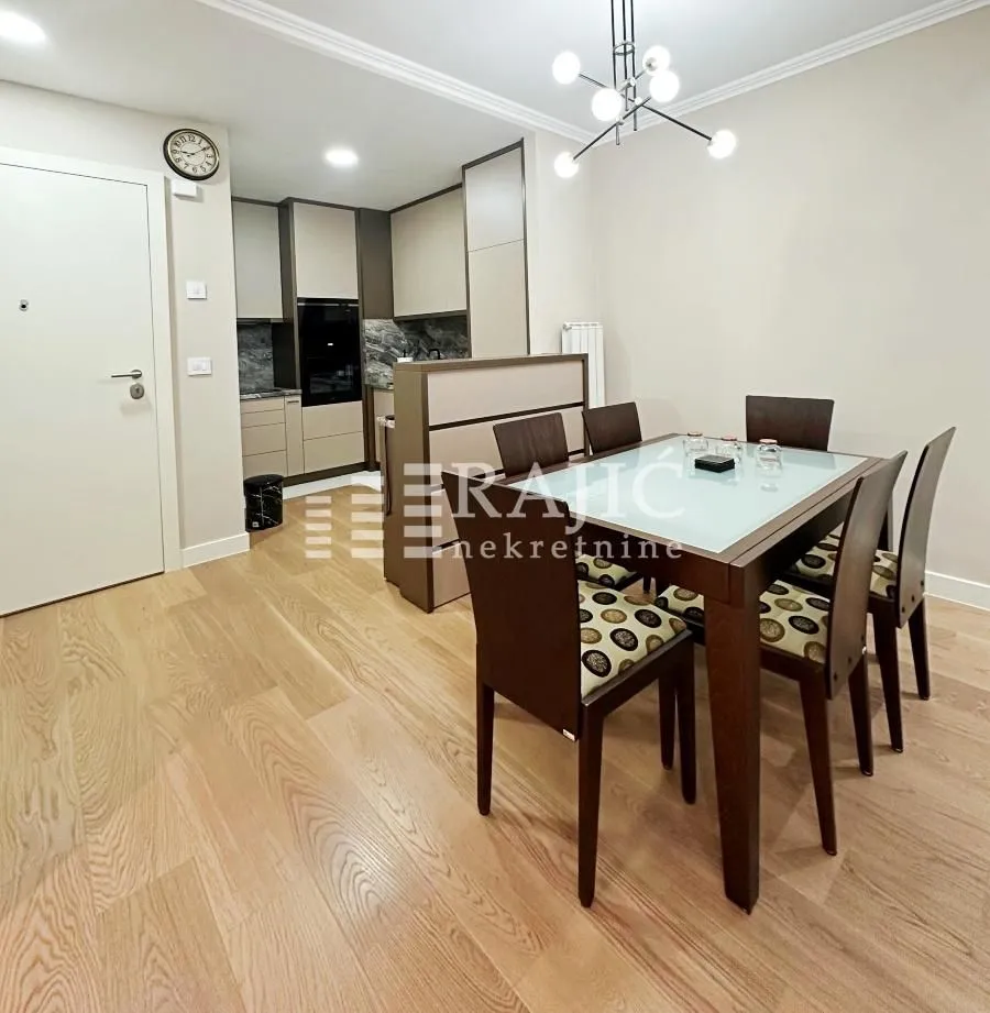 Dining area with a table and chairs overlooking the kitchen.