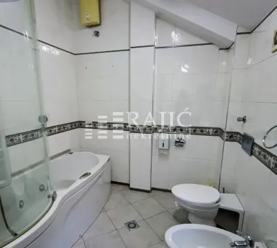 Bathroom equipped with a bathtub, shower cabin, and sanitary fixtures. - image 2