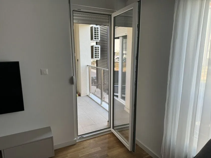 An open balcony door leading to a small terrace.