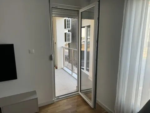 An open balcony door leading to a small terrace. - image 6