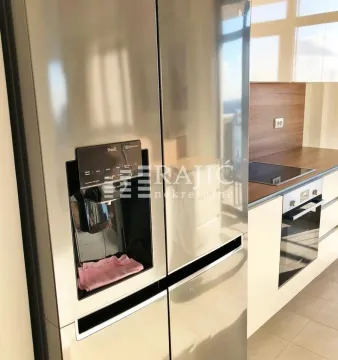 Modern kitchen with a large refrigerator and built-in appliances. - image 14