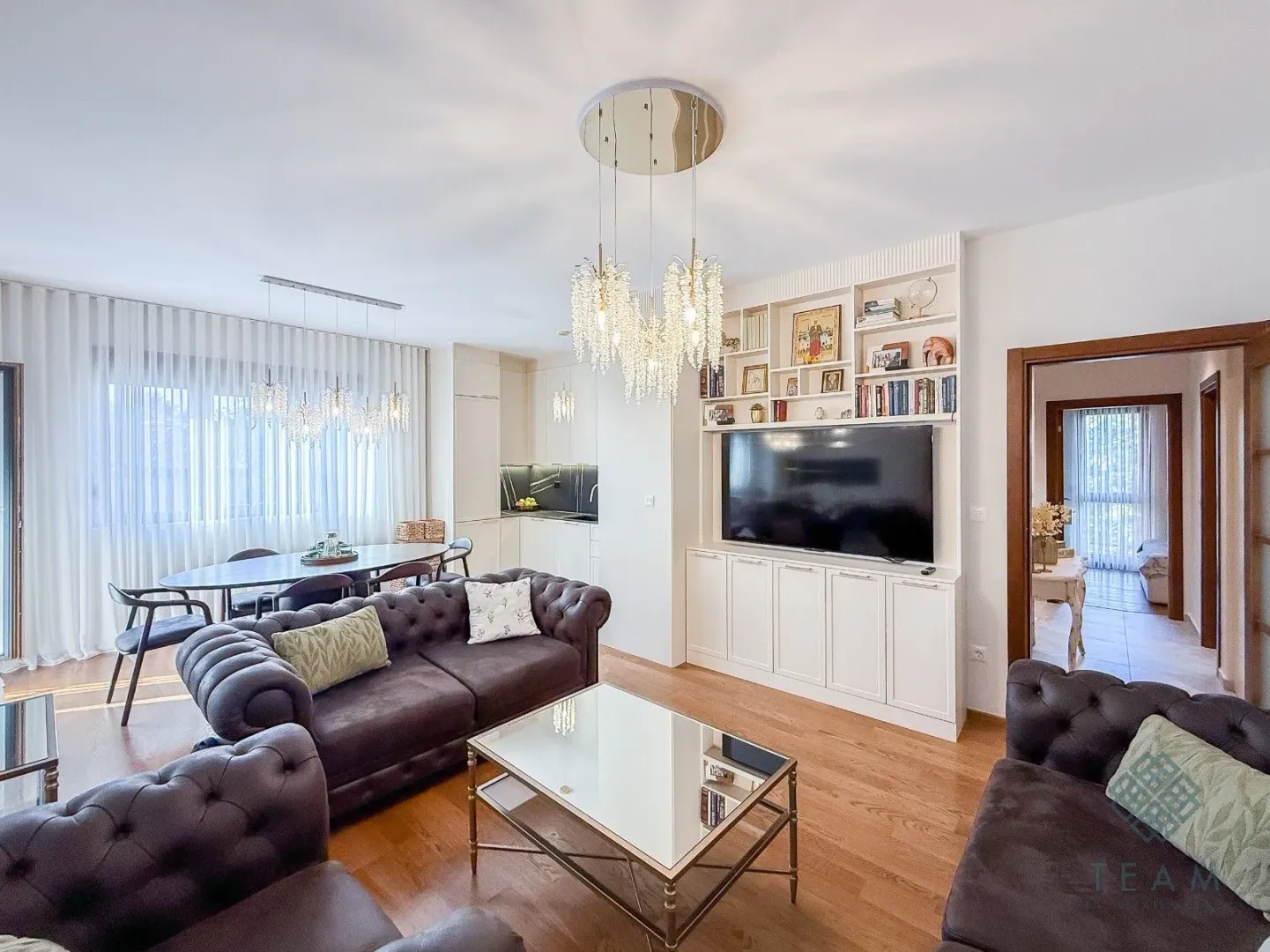 Spacious living room combined with the dining area and kitchen in the background.