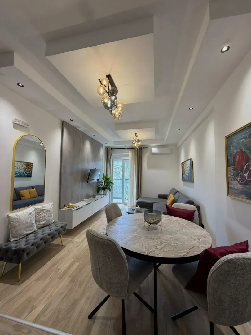 Modern living room with a dining area and elegant lighting.