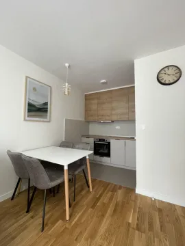 Small kitchen with a dining table and chairs. - image 9