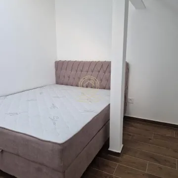 Small bedroom with a double bed and wooden flooring. - image 7