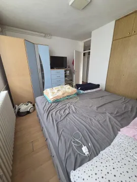 Furnished bedroom with a double bed, wardrobes, and a TV. - image 10