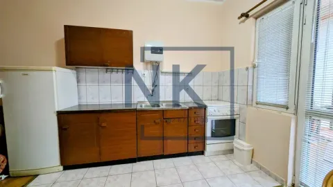Small kitchen with wooden cabinets, refrigerator, stove, and access to the terrace. - image 2