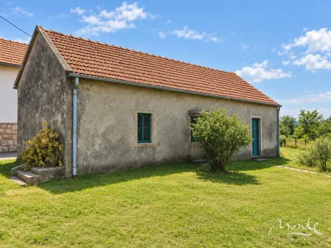 View of an older single-story house with a grassy yard. - image 3