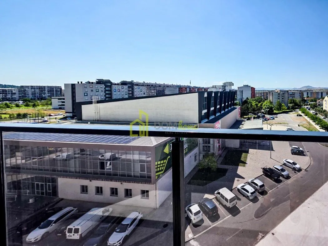 View from the terrace overlooking surrounding buildings and parking lot.