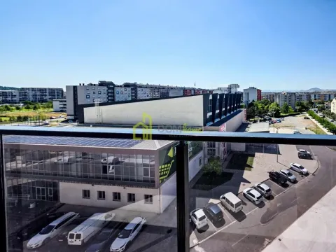 View from the terrace overlooking surrounding buildings and parking lot. - image 15