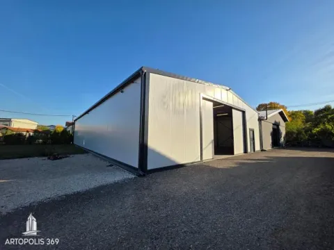 Exterior view of an industrial building with large sliding doors and a driveway. - image 5