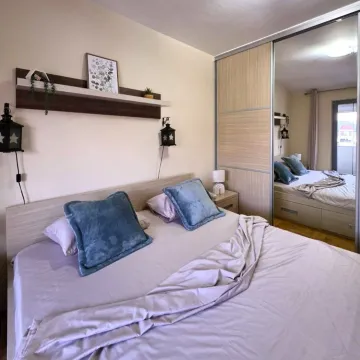 Decorated bedroom with a double bed and a fitted wardrobe with a mirror. - image 6