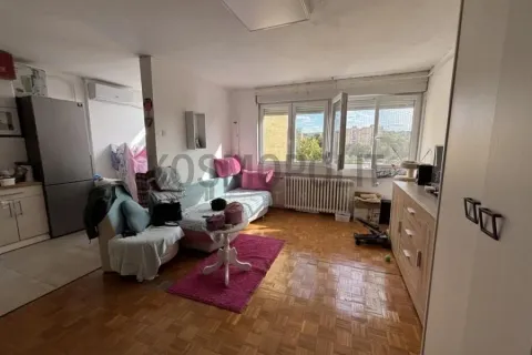 Living room with a sofa set, coffee table, and a window view. - image 2