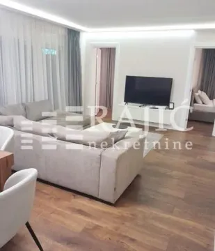 Modern living room with a sofa and TV. - image 2
