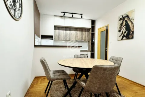 Dining area with a round table and chairs, connected to the kitchen. - image 15