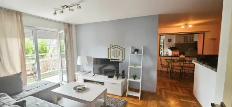 Living room with sofa, TV, and access to the terrace, with a view of the dining area. - image 4