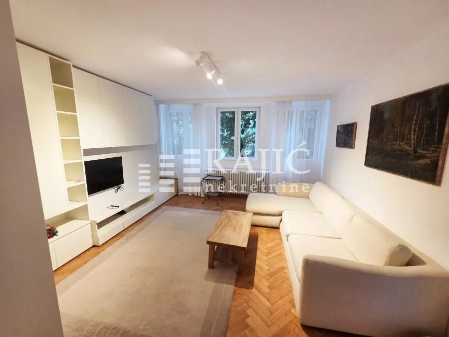 Spacious living room with a sofa and built-in closets.