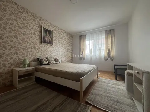 Furnished bedroom with a double bed, bedside table, and patterned wallpaper on the wall. - image 8