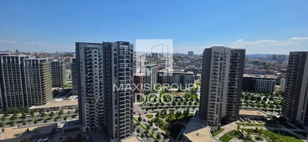View from the window overlooking modern residential buildings and the cityscape.
