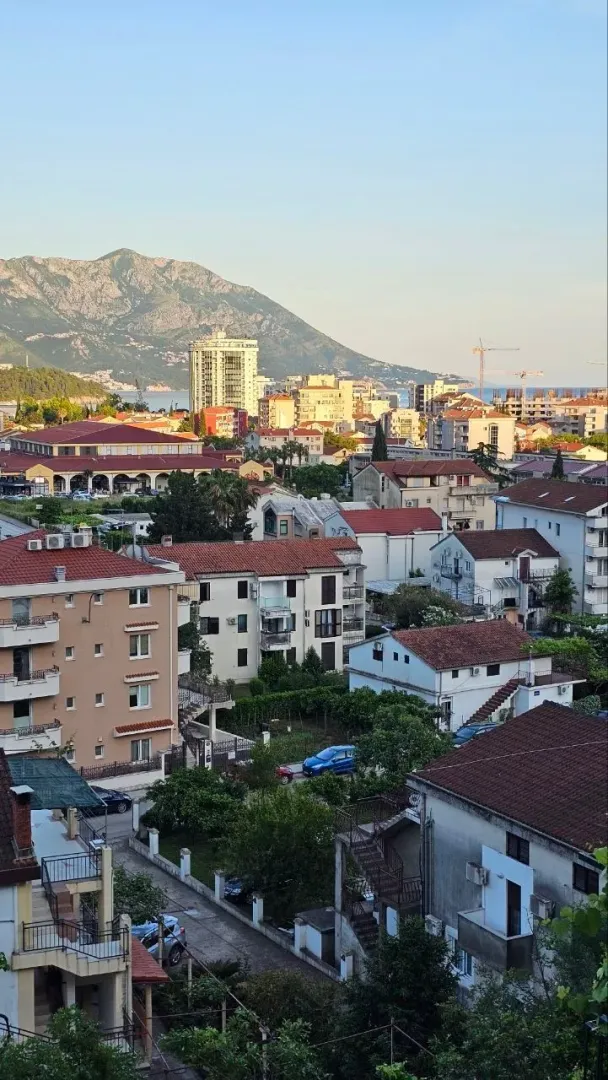 View from the terrace overlooking the city neighborhood and surrounding mountains.