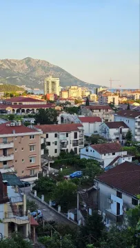 View from the terrace overlooking the city neighborhood and surrounding mountains. - image 7