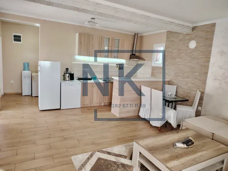 Open-plan space featuring a kitchen, dining area, and part of the living room.