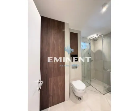 Modern bathroom with a walk-in shower and built-in toilet. - image 16