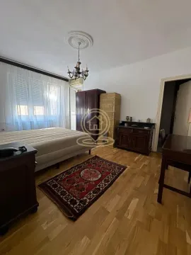 Bedroom with a double bed, wooden furniture, and a traditional rug. - image 12