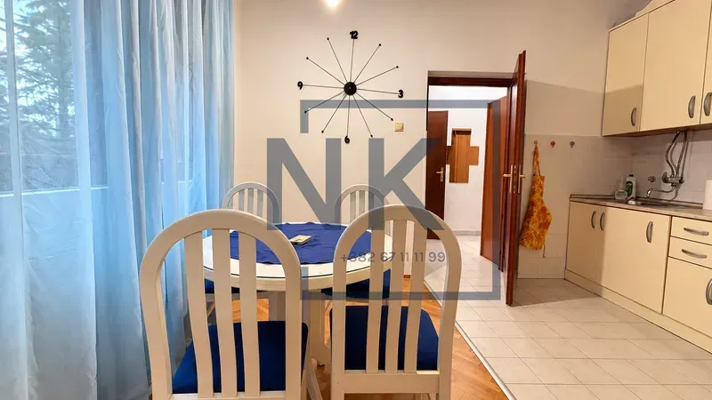 Dining area with a table and chairs, connected to the kitchen.