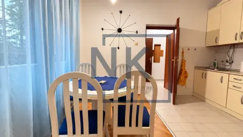 Dining area with a table and chairs, connected to the kitchen. - image 2