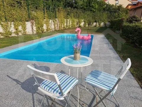 Yard with a swimming pool and seating set. - image 15