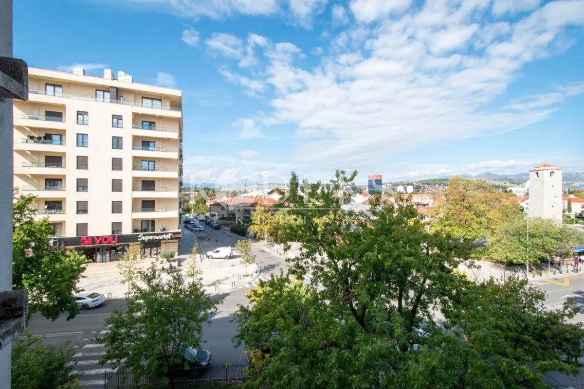 View from the terrace overlooking the city street and surrounding buildings.