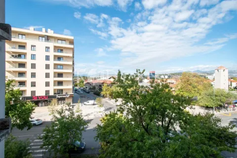 View from the terrace overlooking the city street and surrounding buildings. - image 7
