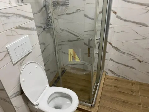Modern bathroom with a shower cabin and a wall-hung toilet. - image 14