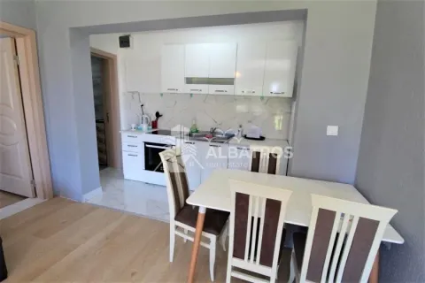 Kitchen with white units and a dining table with chairs. - image 7