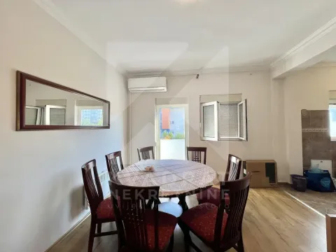 Dining area with a table, chairs, and a wall mirror. - image 2