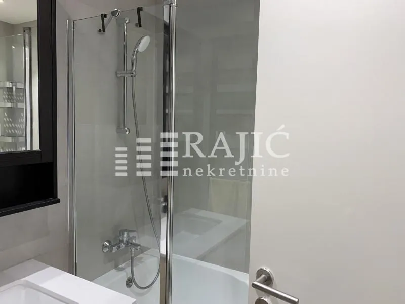 Modern bathroom with a shower cabin and sink.