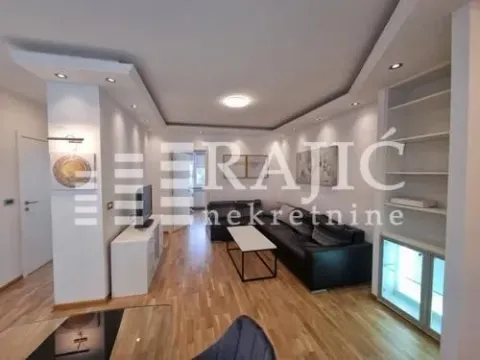 Living room with sofa, TV unit and recessed lighting. - image 6