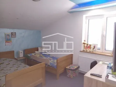 Children's bedroom with two wooden beds, a desk, and a window. - image 7