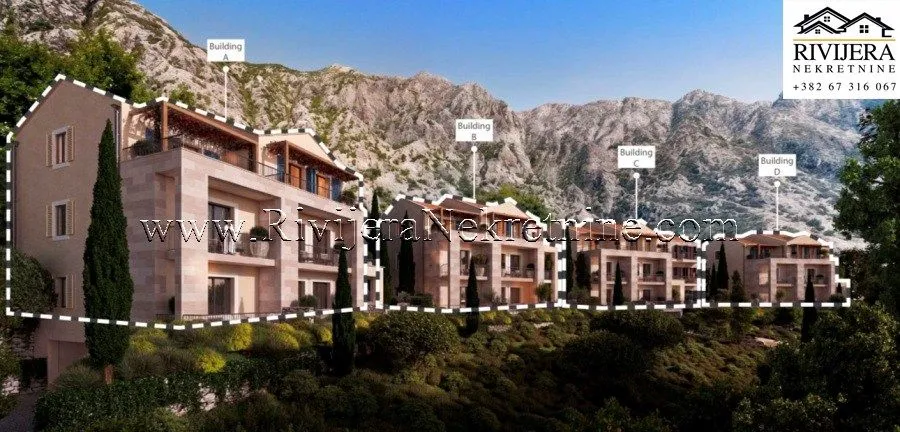 Spoljašnji prikaz kompleksa zgrada sa planinskom pozadinom.